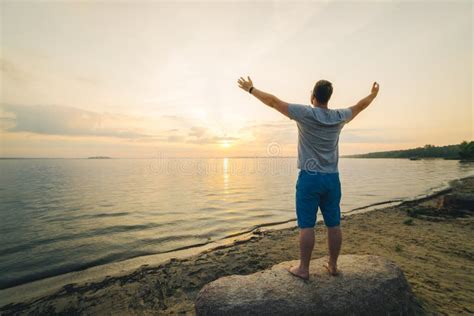 Man On The Beach Looking On Sunrise With Hands Up Stock Photo Image