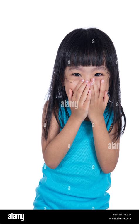 Asian Chinese Little Girl Laughing And Covering Her Mouth In Isolated