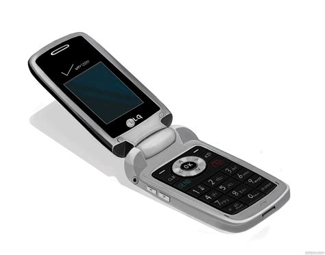 An Old Cell Phone Sitting On Top Of A White Surface