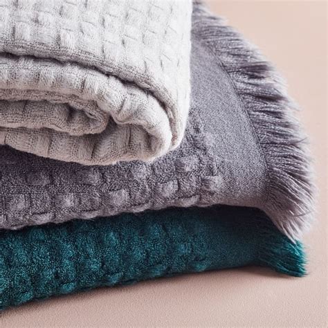 Three Blankets Folded On Top Of Each Other