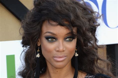 Tyra Banks Gets Our Attention With Big Hair Major Makeup And Plunging