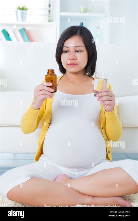 Pregnant Woman Taking Supplements At Home Stock Photo Alamy