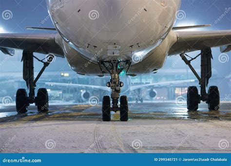 Airplane On Winter Frosty Night At Airport During Snowfall Stock Image