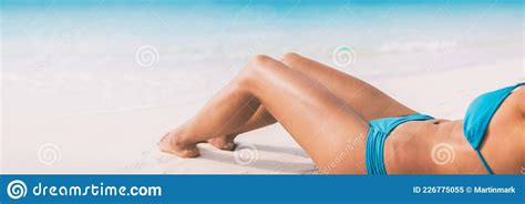 Summer Beach Bikini Body Woman Lying On White Sand Sun Tanning Smooth Legs Sun Tan For Laser