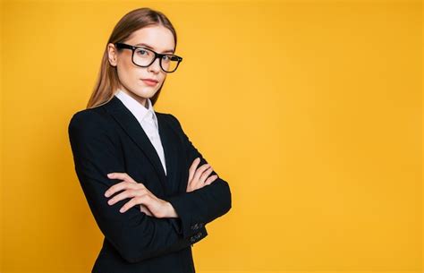 premium photo happy cute blonde business woman portrait in glasses over yellow wall