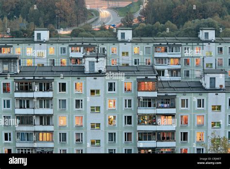 Apartment Buildings In The Evening With Lights In Windows Russia