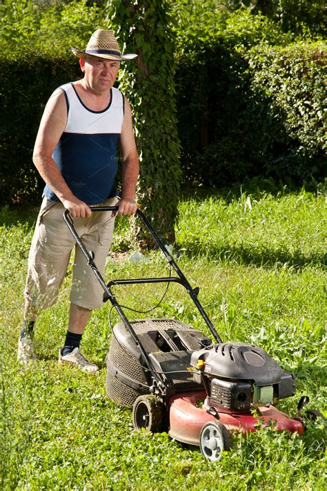 Thus, let us talk about lawn care business names and slogans. Man mowing the lawn ~ People Photos ~ Creative Market