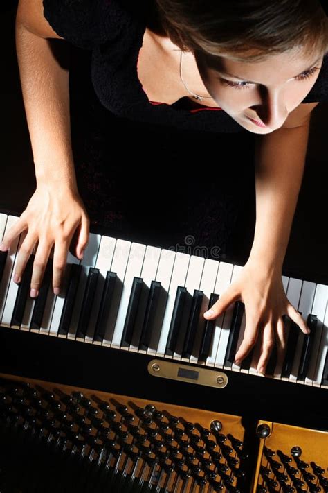 Pianist Playing A Piece On A Grand Piano At A Concert Seen From The