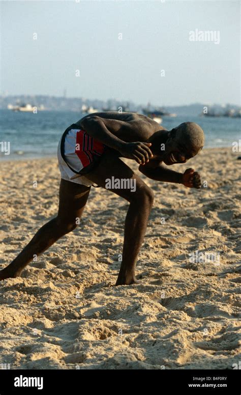 Man Bent Over In Excitement And Laughter On Beach Luanda Angola Stock