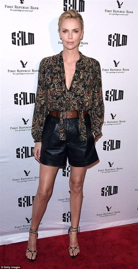 charlize theron is leggy in leather shorts with patterned blouse leather shorts fashion