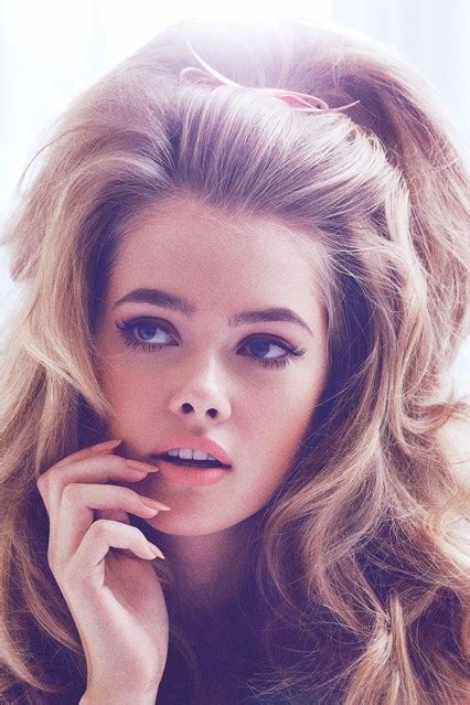 In this photo, you can see how she boasts wavy caramel locks with sunny highlights styled with a center part. Retro 60's Hairstyles