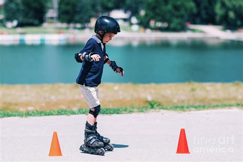 Boy Learning To Roller Skate Photograph By Microgen Imagesscience