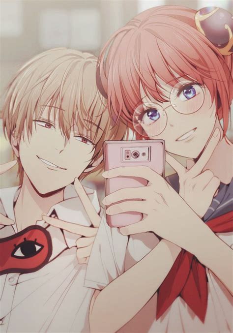 Two Anime Characters Taking A Selfie With Their Cell Phone