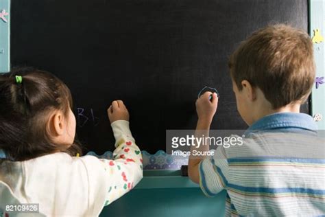 Children Writing On A Blackboard Foto Stock Getty Images