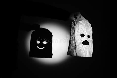 Man Holding Kraft Paper Bag With Eyes And Mouth Criminal Mask In