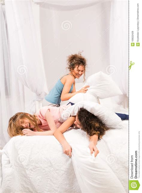 Girls In Bed Having Pillow Fight In Pajamas Stock Image Image Of