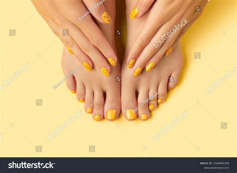 Womans Hands Feet On Yellow Background Stock Photo 2164965309