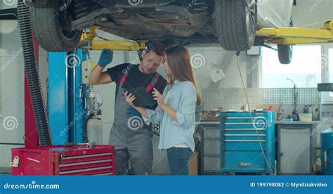 Mechanic Teaching Woman To Repair Car Woman Learning And Noting Or