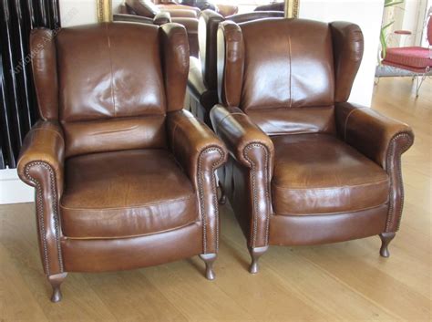 Back legs are moderately carved with a dramatic rake. Pair Leather Wing Arm Club Chairs - Antiques Atlas
