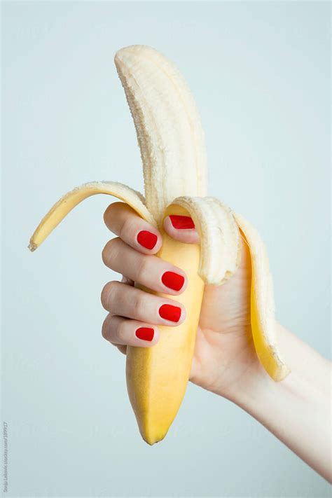 Female Hand Holding A Peeled Banana By Stocksy Contributor Sonja