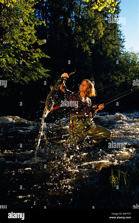 A Woman Catching A Fish Stock Photo Alamy