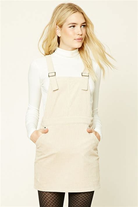 A Corduroy Overall Mini Dress Featuring Adjustable Buckled Straps