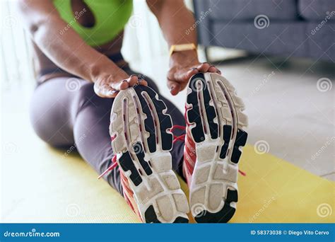 Home Fitness Black Woman Doing Workout Stretching On Pad Stock Photo