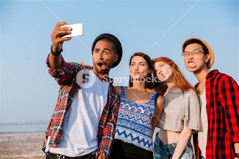 Group Of Friends Taking Selfie And Making Funny Faces Outdoors Royalty