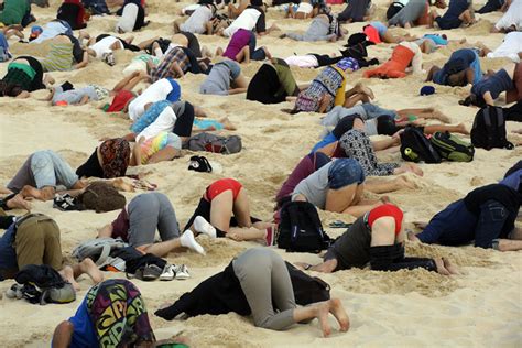 G20 Climate Change Protesters Bury Their Heads In The Sand Photos