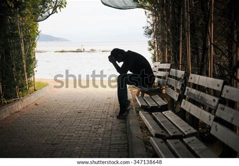 Depressed Young Man Sitting On Bench Stock Photo Edit Now