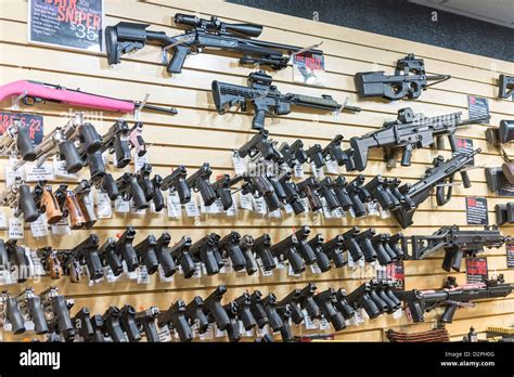 A Large Variety Of Guns Rifles And Weapons At A Gun Store Stock Photo