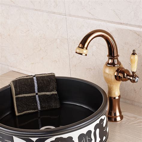 A brushed gold gooseneck faucet paired with a farmhouse sink is mounted beneath a window and in front of honed marble subway backsplash tiles. Fulmer Single Handle Luxury Rose Gold Brass & Ceramic ...