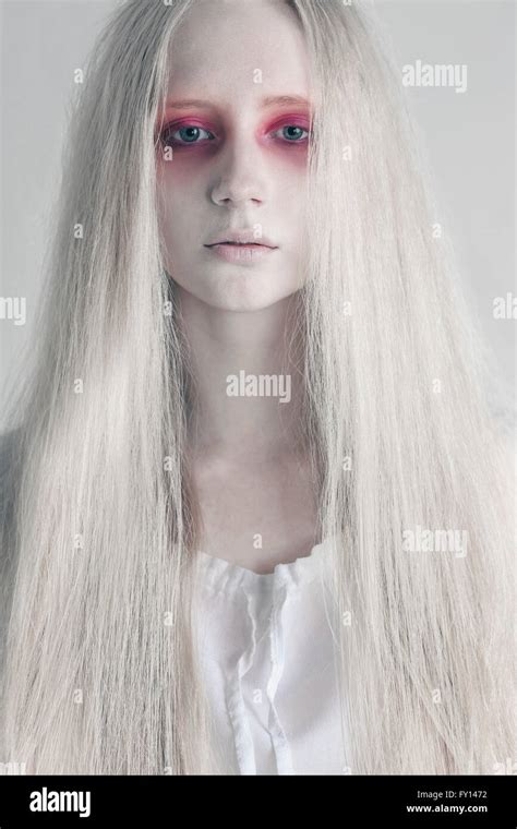 Young Woman With Spooky Red Eyes And Long Hair Against White Background