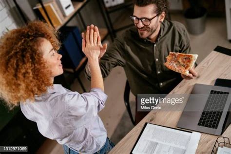 coworkers eating pizza photos and premium high res pictures getty images