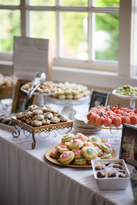 A Table Topped With Lots Of Desserts And Pastries On Top Of A White