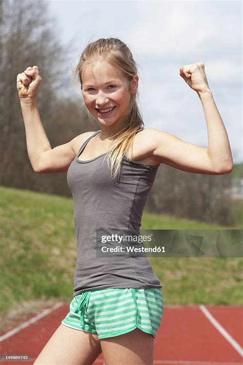 Austria Teenage Girl On Track Showing Her Muscles Smiling Portrait Stock Foto Getty Images