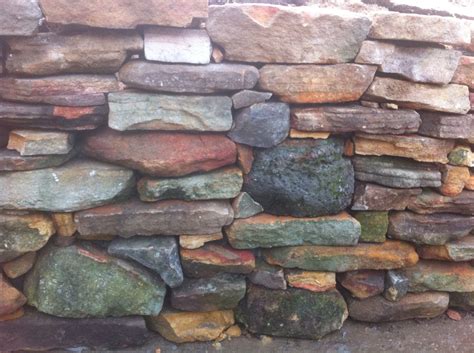 Used to create raised garden beds or a natural capping to a masonry wall, sandstone can bring an extra dimension. Rubble sandstone retaining wall | Retaining wall, Garden ...