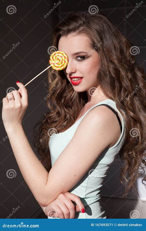 Beautiful Fashionable Woman Eats Delicious Sweet Candy Lollipop On A Stick Stock Image Image