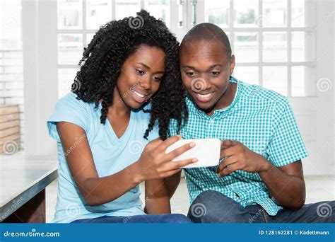 African American Couple Watching Tv Online On Phone Stock Image Image
