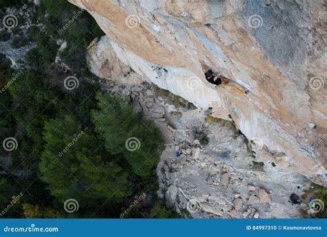 Outdoor Sport Rock Climber Ascending A Challenging Cliff Extreme