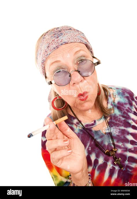 Senior Hippie Lady With Cigarette And Blowing Smoke Rings Stock Photo