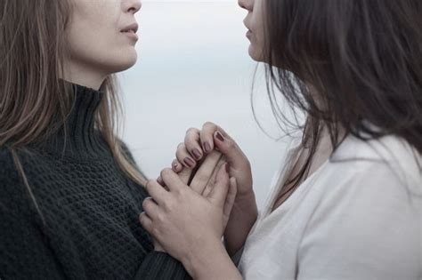 Close Up Of Lesbian Couple Holding Hands By The Ocean Character