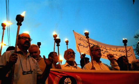 Pakistani Laborers Take Part In A Torch Rally On The Eve Of