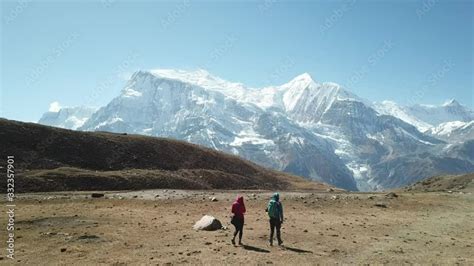 couple trekking to ice lake part of the annapurna circuit trek himalayas nepal they are