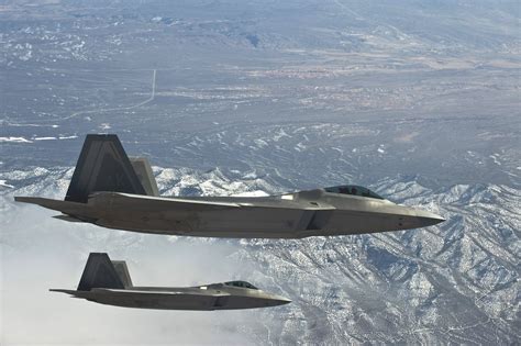 u s air force usaf f 22a raptor stealth fighter jets soar over the nevada test and training