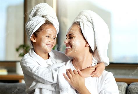Premium Photo Happy Smiling And Relaxed Mother And Daughter Spa Day At Home With Face Masks