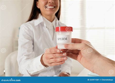 donor giving container of sperm to doctor in hospital stock image image of diagnostic