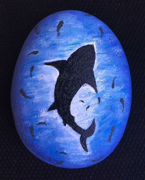 A Painted Rock With An Image Of A Shark On It