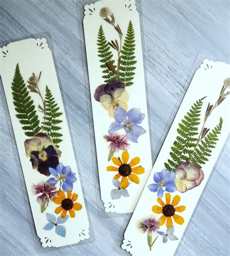 Framing them is one option, as is gluing them into your wedding guestbook, showing off your pressed flowers into the back of a clear phone case, or even turning them into petal paper. PRESSED FLOWER BOOKMARKS Set of 3 Bookmarks Pressed Dried ...