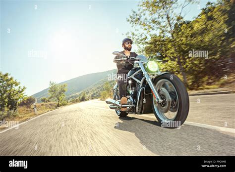 Biker Riding A Motorcycle On Open Road Stock Photo Alamy